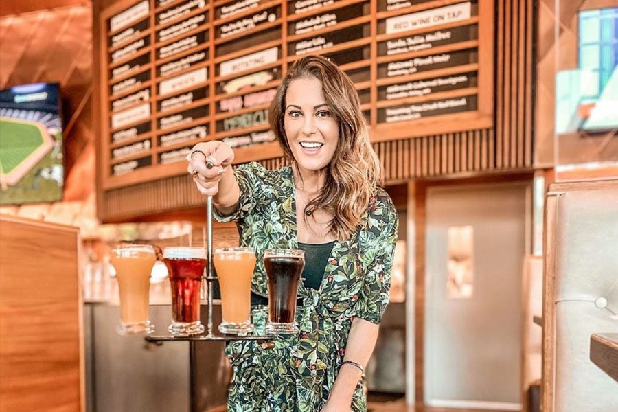 Woman holding beer flight