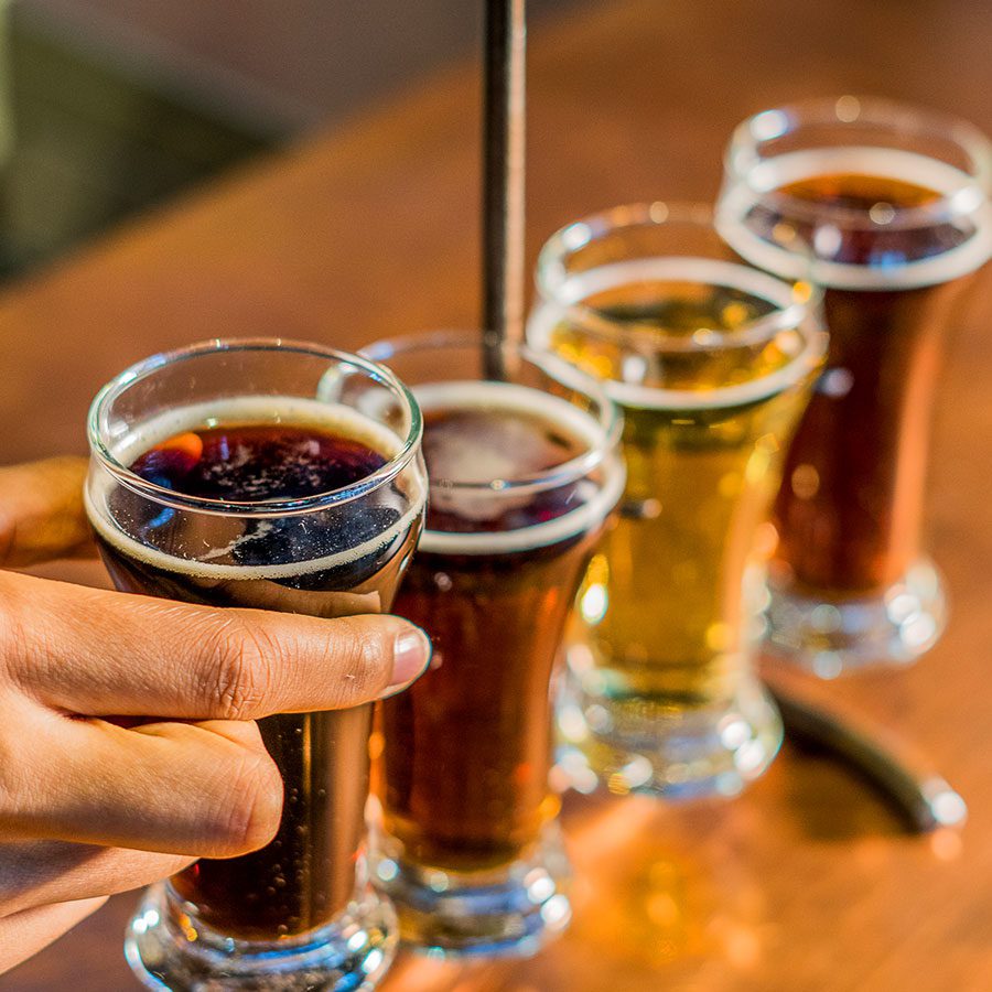 Hand with beer flight